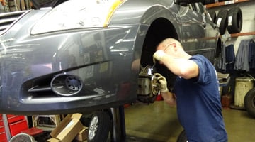 Image of a mechanic working on car brakes at Hollenshade's Service