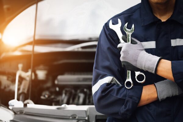 Image of an auto mechanic holding tools at a vehicle maintenance garage on Hollenshade's automotive services website
