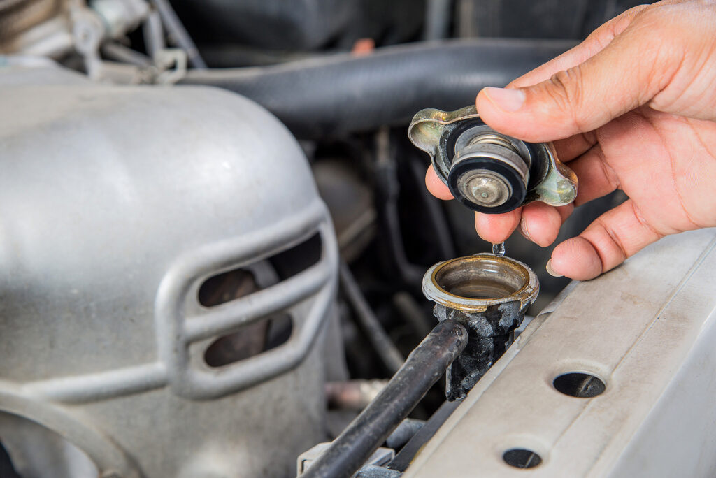 A mechanic working on a cooling system